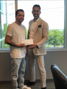 Nassau Personal injury lawyer Frank Bruno with a happy client and their settlement check