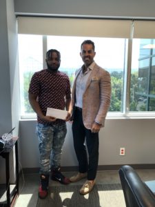 Nassau Personal injury lawyer Frank Bruno with a happy client and their settlement check